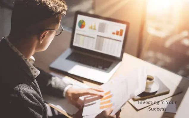 A man reviewing charts on a laptop while comparing reports in hand, preparing himself for success.