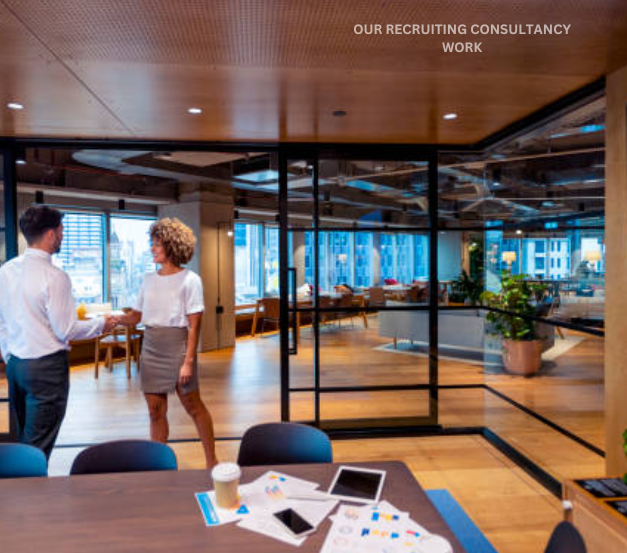 A man and woman stand in a conference room, engaged in a discussion shows recruitment agencies work